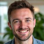 Portrait of Liam, Community Manager, engaging with others